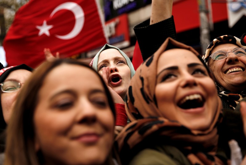 Supporters of Turkish President Erdogan cheer during a rally for the upcoming local elections in Istanbul
