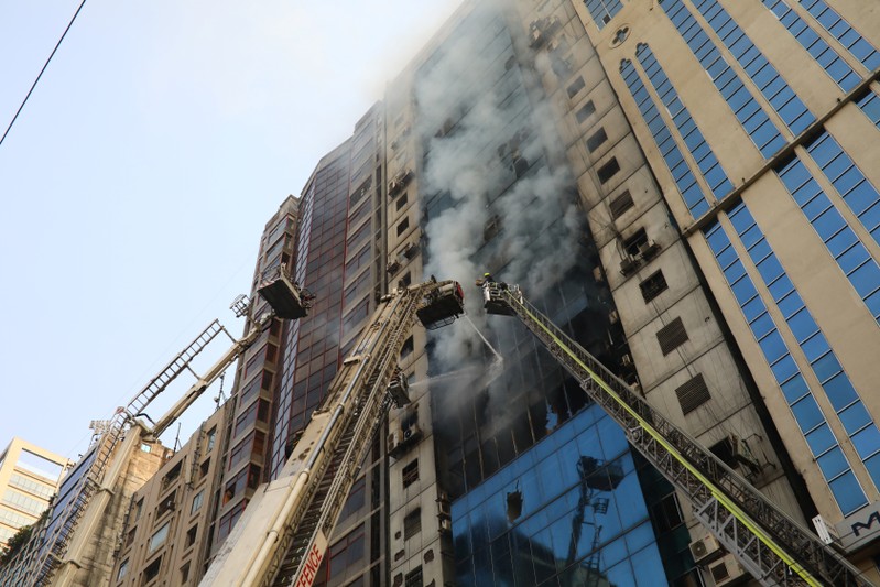 Firefighters attempt to extinguish a fire at a multi-storey commercial building in Dhaka