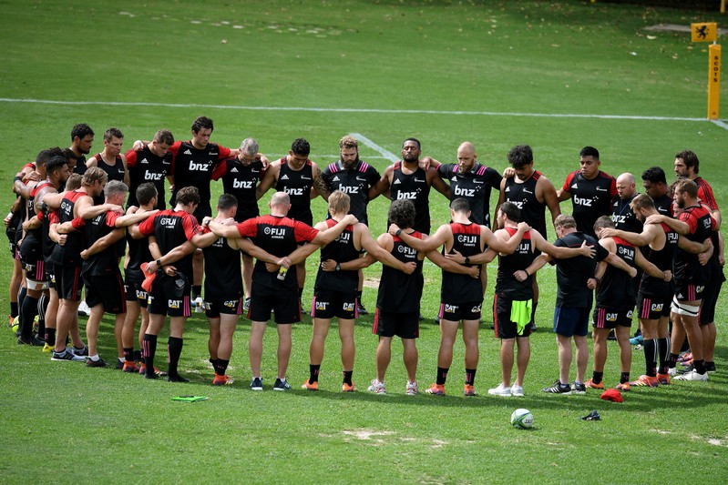 Canterbury Crusaders players and staff pause during their Captain's Run training session for two minute's silence, a week on from the Christchurch attack, at 11.32am Sydney time, at The Scots College, in Sydney