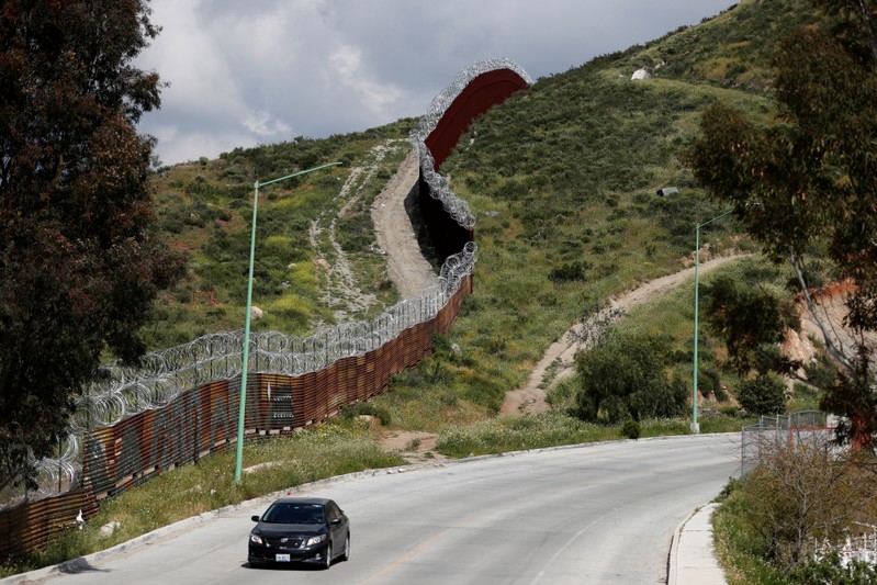 The old (bottom R) and the new border fence dividing U.S. and Mexico is seen from Tecate