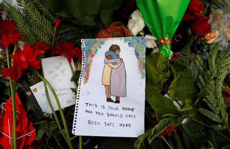 Flowers and signs are pictured at a memorial as a tribute to victims of the mosque attacks, near a police line outside Masjid Al Noor in Christchurch
