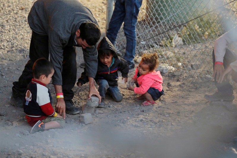 FILE PHOTO: Migrants from Central America are seen inside an enclosure, where they are being held by U.S. Customs and Border Protection (CBP), after crossing the border between Mexico and the United States illegally and turning themselves in to request asy