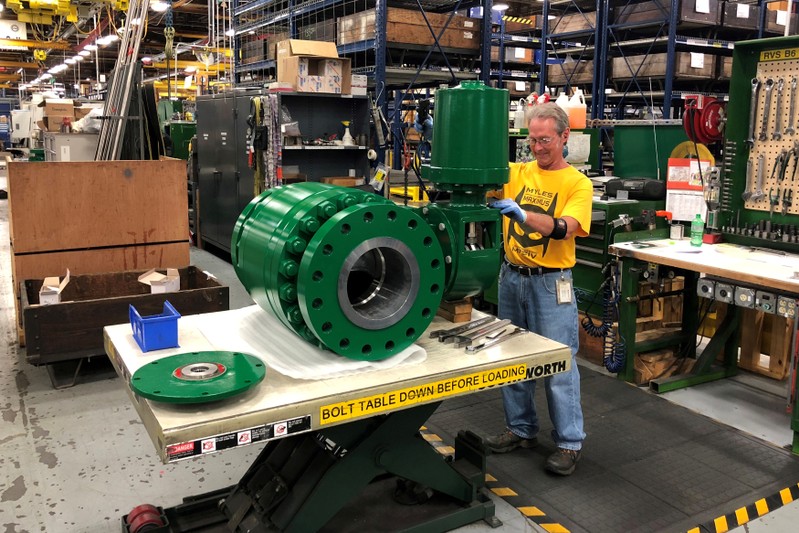 FILE PHOTO: A worker assembles an industrial valve at Emerson Electric Co.’s factory in Marshalltown Iowa