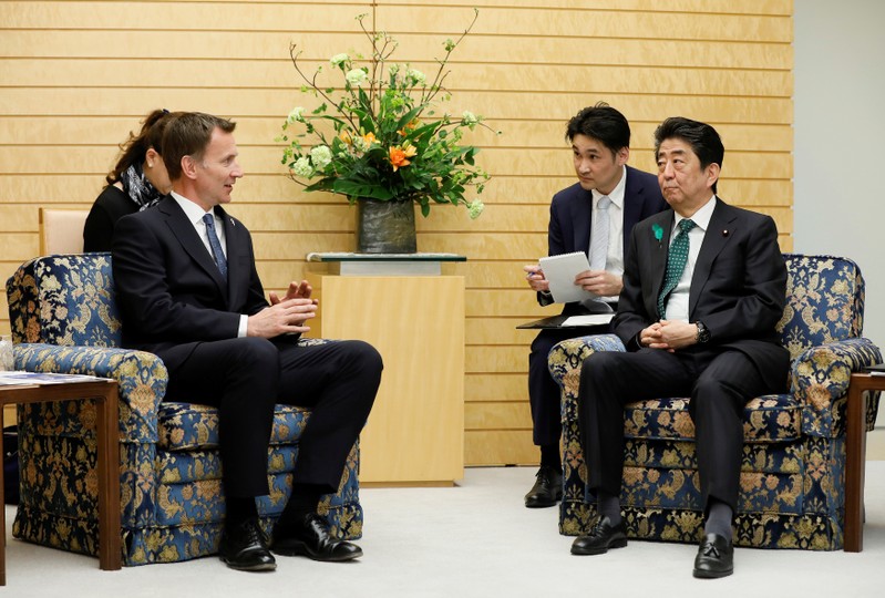 Jeremy Hunt, British Secretary of State for Foreign and Commonwealth Affairs, talks with Japanese Prime Minister Shinzo Abe