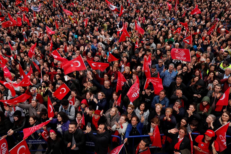 Supporters of main opposition CHP wave flags as they listen to mayoral candidate Ekrem Imamoglu during a gathering in Istanbul