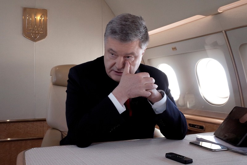 FILE PHOTO: Ukraine's President Poroshenko speaks during an interview on board his plane on the way from Berlin to Paris