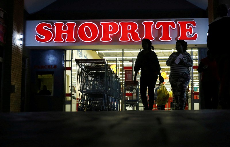 FILE PHOTO: Shoppers leave the Shoprite store in Daveyton