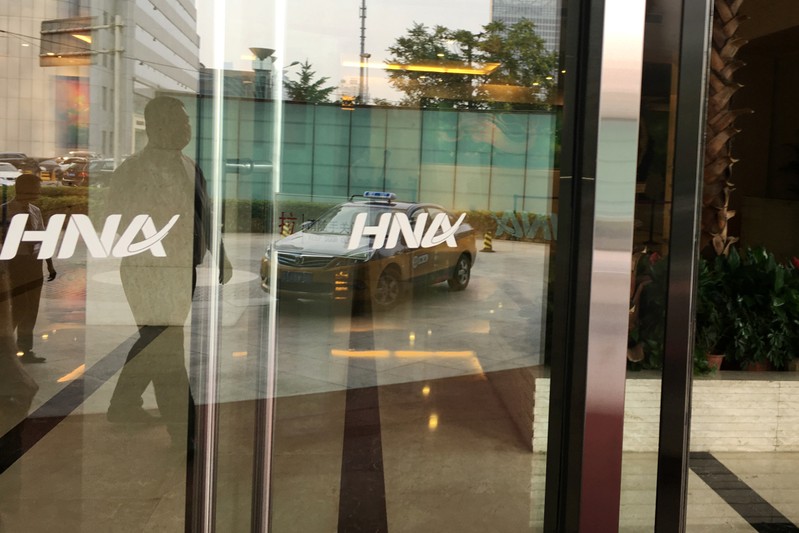 The HNA Group logo is seen on the gate of HNA Plaza building in Beijing