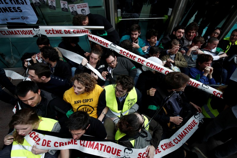 Environmental activists block the entrance of the French bank Societe Generale headquarters during a