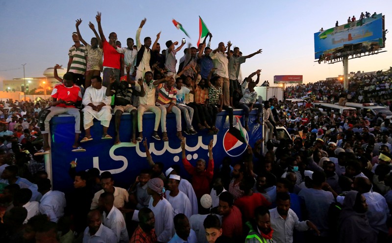 Sudanese demonstrators chant slogans as they attend a mass anti-government protest outside Defence Ministry in Khartoum