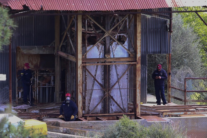 Rescuers search a mine shaft at a mine where two women were found dead, near the village of Mitsero in Cyprus