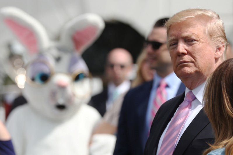 A person in an Easter Bunny costume looks on as U.S. President Trump attends the 2019 White House Easter Egg Roll in Washington