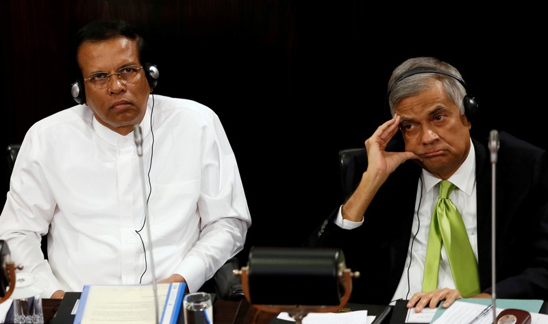 FILE PHOTO: Sri Lanka's President Maithripala Sirisena and Prime Minister Ranil Wickremesinghe look on during a Parliament session marking the 70th anniversary of Sri LankaÕs Government, in Colombo