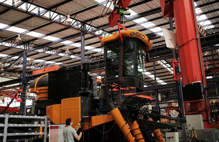 Employees work at a harvest machine assembly line at the AGCO Agricultural Machinery Plant in Ribeirao Preto