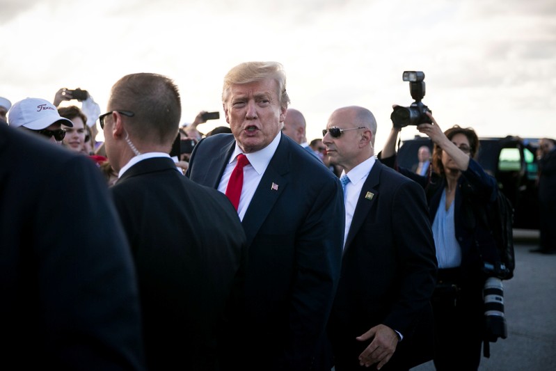 U.S. President Donald Trump and U.S. first lady Melania Trump arrive aboard Air Force One at Palm Beach International Airport