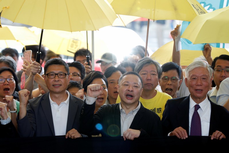 Pro-democracy activists arrive at the court for sentencing on their involvement in the Occupy Central, in Hong Kong