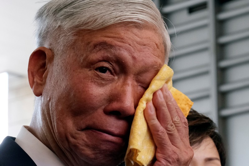Occupy Central pro-democracy movement founder Chu Yiu-ming cries as he speaks to the media after getting his suspended sentence on his involvement in the Occupy Central, also known as