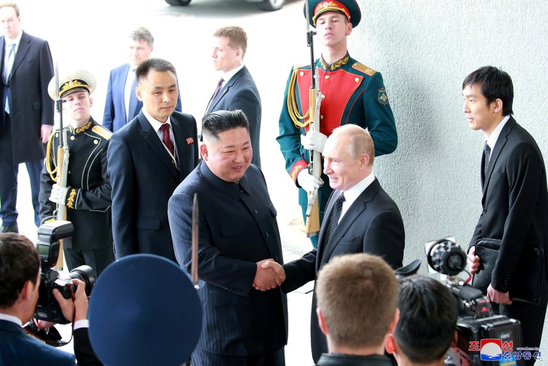 North Korean leader Kim Jong Un shakes hands with Russian President Vladimir Putin in Vladivostok