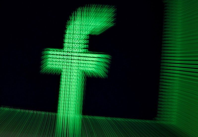 FILE PHOTO: A 3D-printed Facebook logo are seen in front of displayed binary digits in this illustration