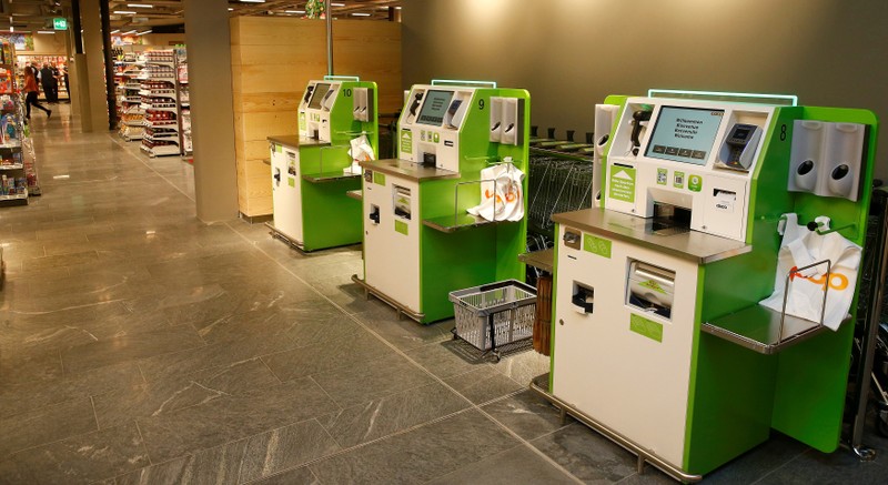 FILE PHOTO: Self checkout machines are seen at a supermarket of Swiss retail group Coop in Zumikon