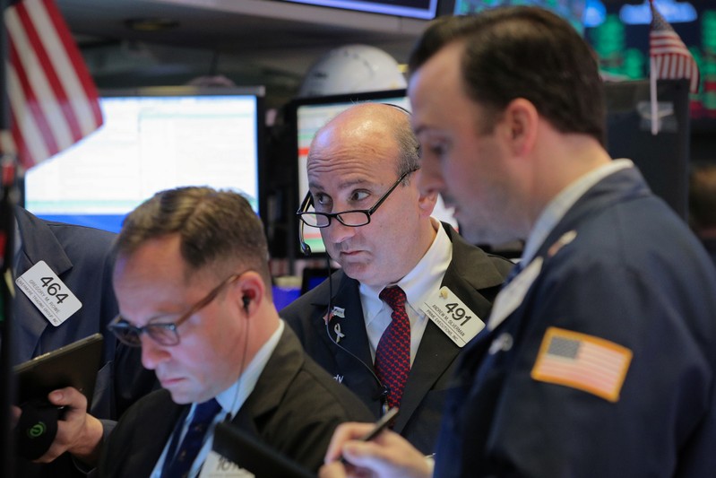 Traders work on the floor at the NYSE in New York