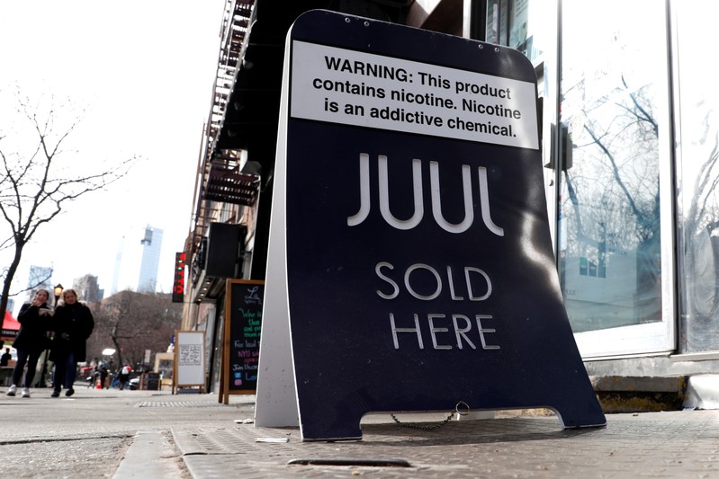 A sign advertising Juul brand vaping products is seen outside a shop in Manhattan in New York City