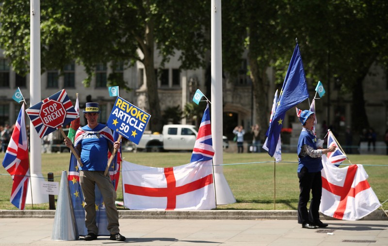 Anti-Brexit protesters are seen outside the Houses of Parliament in London