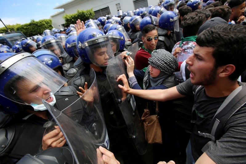 FILE PHOTO: Students and police confront each other during an anti-government protest in Algiers