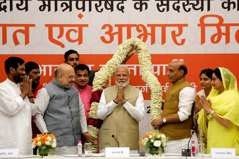 FILE PHOTO: India's PM Modi gestures as he is presented with a garland during a thanksgiving ceremony by BJP leaders to its allies at the party headquarters in New Delhi,
