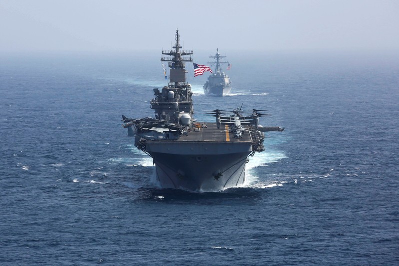 FILE PHOTO: The U.S. Navy amphibious assault ship USS Kearsarge and the Arleigh Burke-class guided-missile destroyer USS Bainbridge sail in the Arabian Sea