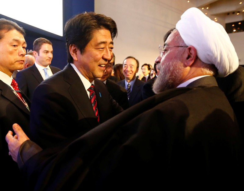 FILE PHOTO: Japan's Prime Minister Abe greets Iran's President Rouhani at World Economic Forum in Davos