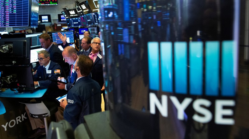 Traders work on the floor at the New York Stock Exchange (NYSE) in New York