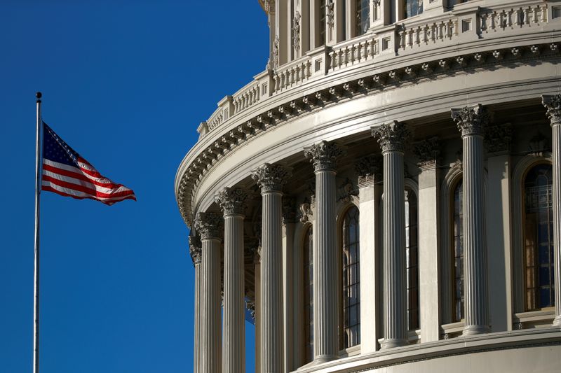 FILE PHOTO: A U.S. flag flies outside of the Capitol dome ahead of the House of Representatives resolution appointing managers for Trump impeachment trial