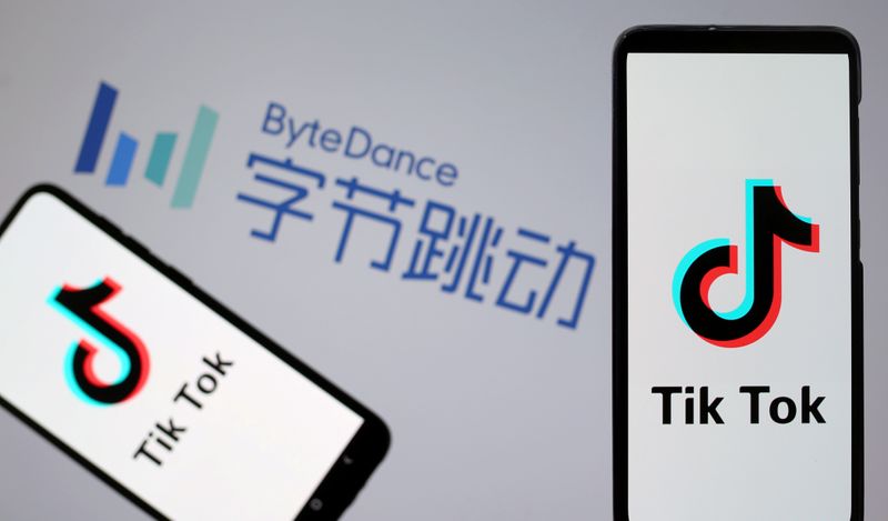 FILE PHOTO: TikTok logos are seen on smartphones in front of displayed ByteDance logo in this illustration