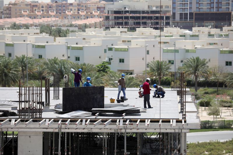 Workers wearing protective face masks work on a residential construction site, following the outbreak of coronavirus disease (COVID-19), in Dubai
