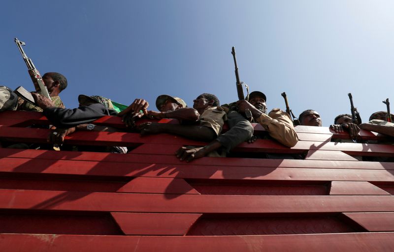 FILE PHOTO: FILE PHOTO: Members of Amhara region militias ride on their truck as they head to the mission to face the Tigray People's Liberation Front in Sanja