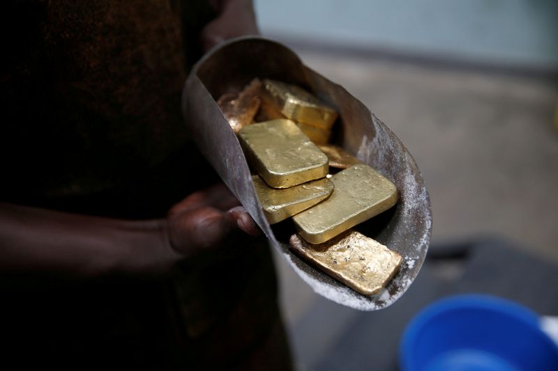 FILE PHOTO: An employee holds gold bars before the refining process at AGR (African Gold Refinery) in Entebbe